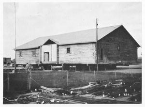 Moving of the Big Piney Community Hall. By this time the building had a new roof and roofline.